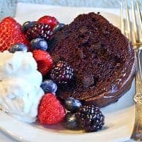 Berry Glazed Chocolate Cake - a moist devil's food cake topped with a raspberry glaze and chocolate icing. Perfect for any celebration. https://www.lanascooking.com/berry-glazed-chocolate-cake/
