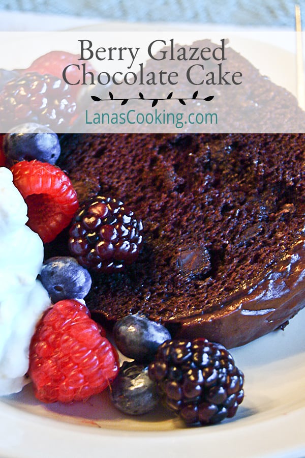 Berry Glazed Chocolate Cake - a moist devil's food cake topped with a raspberry glaze and chocolate icing. Perfect for any celebration.  https://www.lanascooking.com/berry-glazed-chocolate-cake/