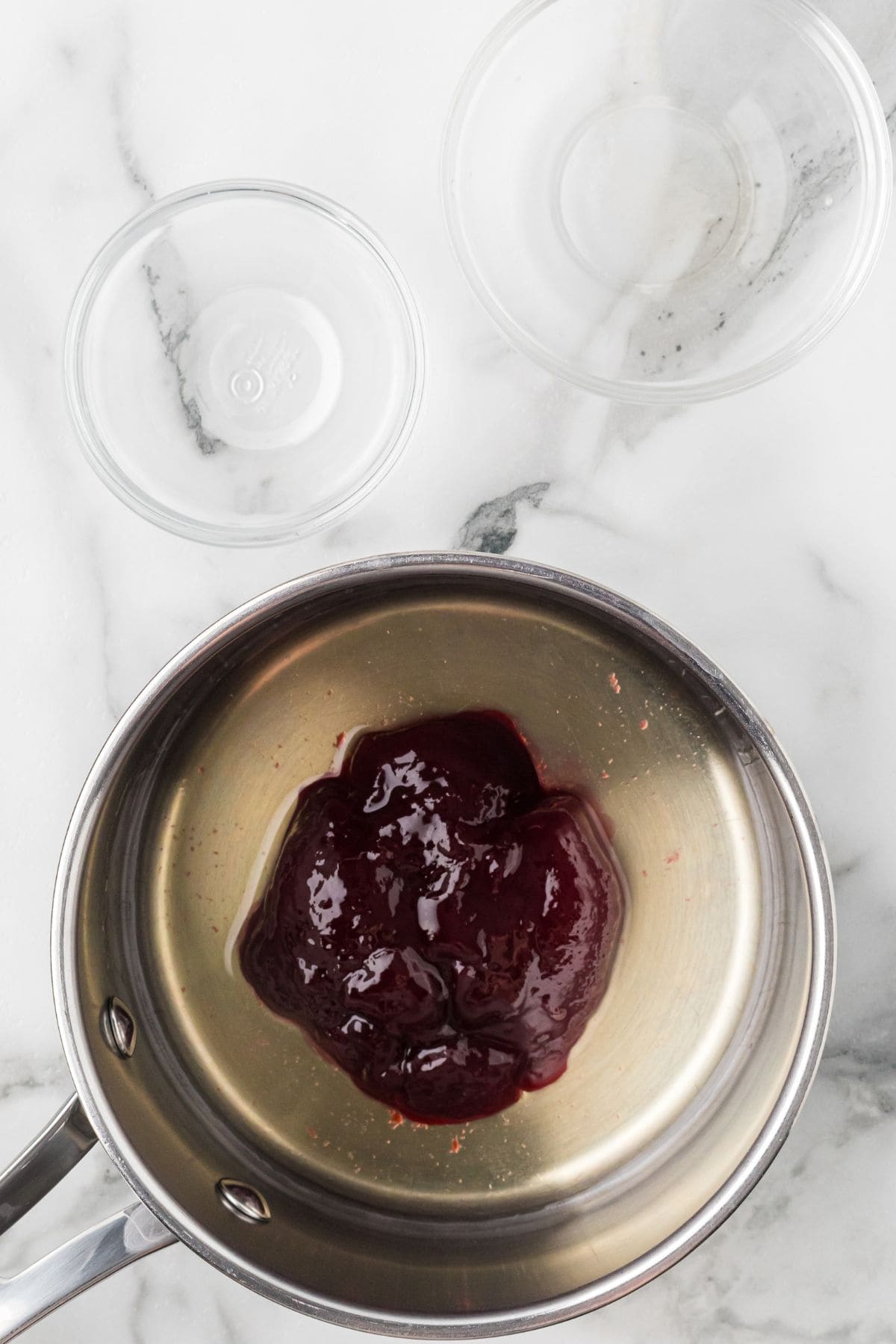Raspberry glaze ingredients in a saucepan.