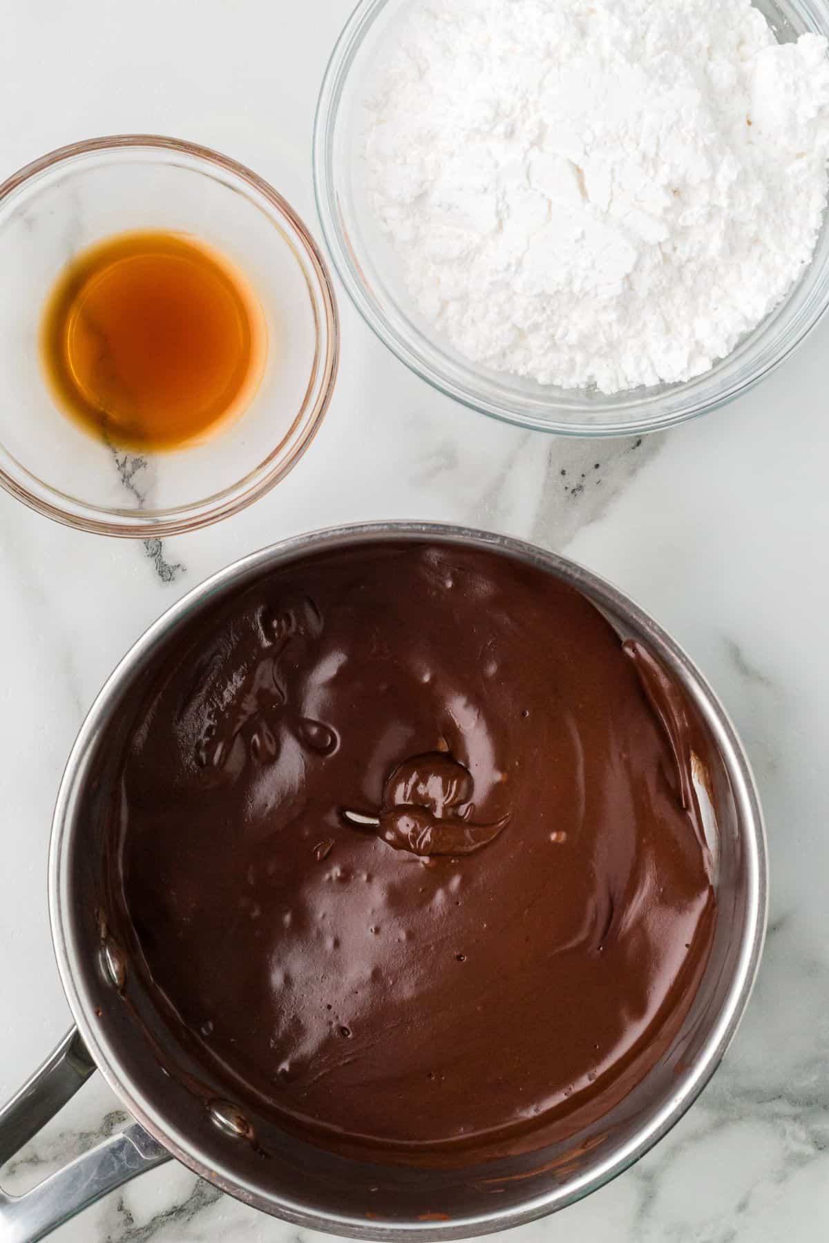 Cooked cocoa, cream, and butter in saucepan.