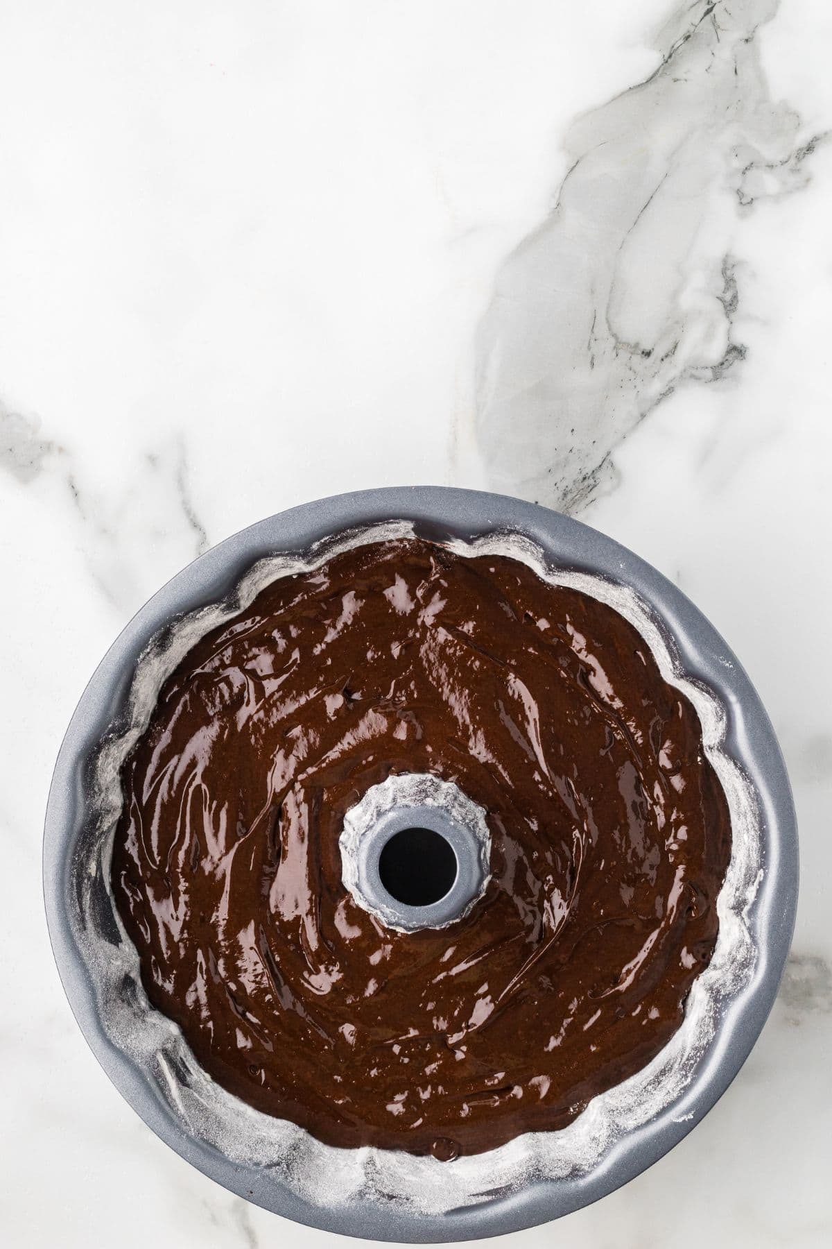 cake batter after being poured into the prepared pan.