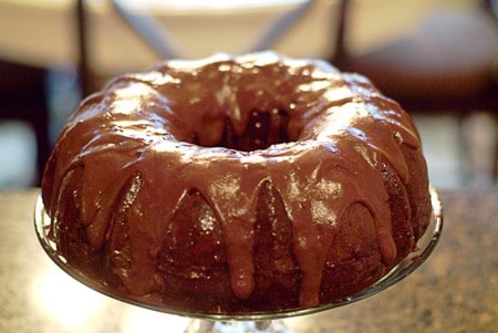 Drizzle cooled and glazed cake with the chocolate icing
