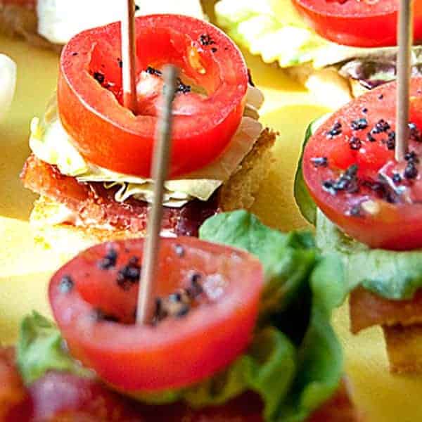 BLT Bites are perfect tiny appetizer sized single bite BLTs on sourdough bread. Serve with cocktails, as a first course, or as finger food for any party. https://www.lanascooking.com/blt-bites/