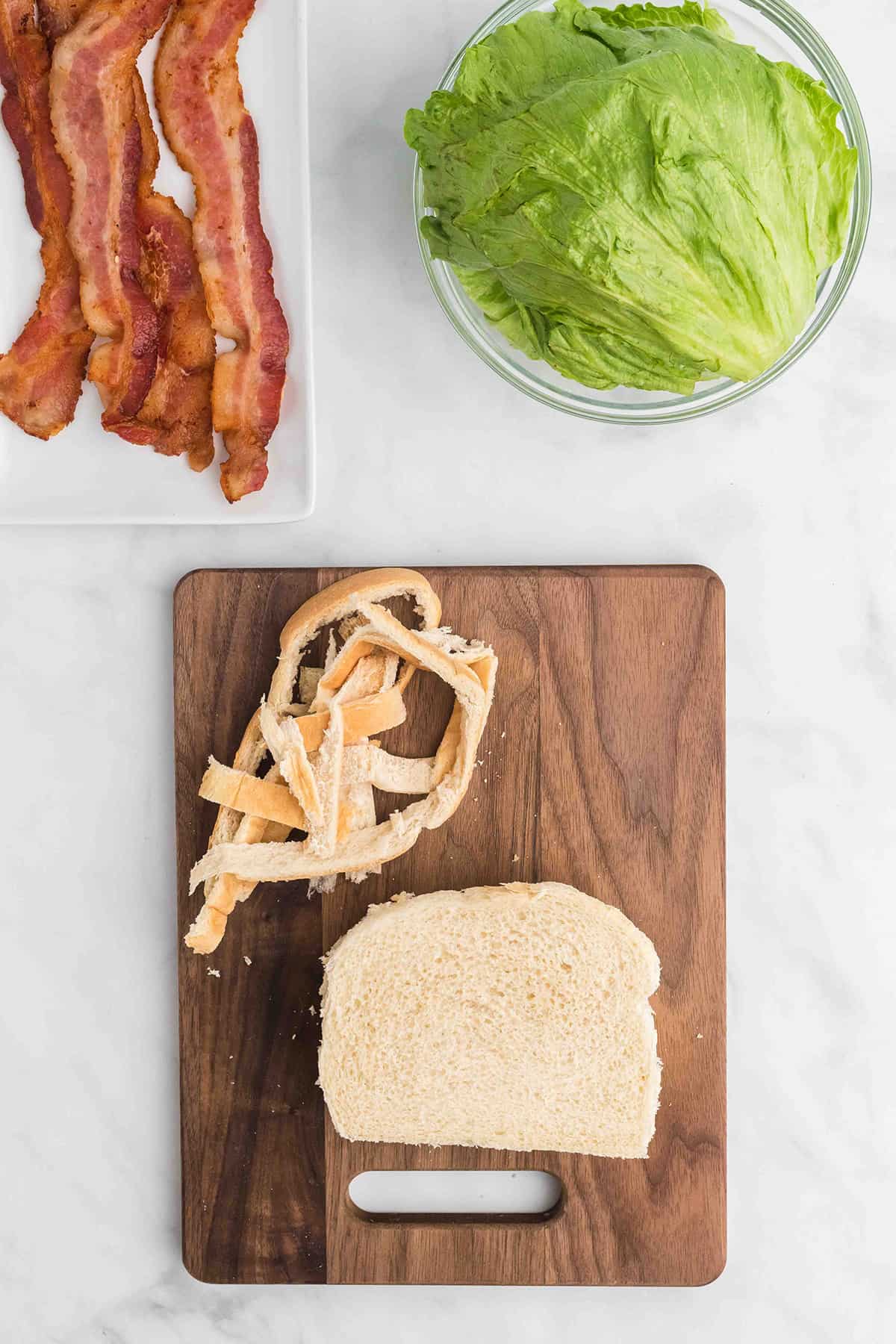 Bread on a cutting board with crusts removed.