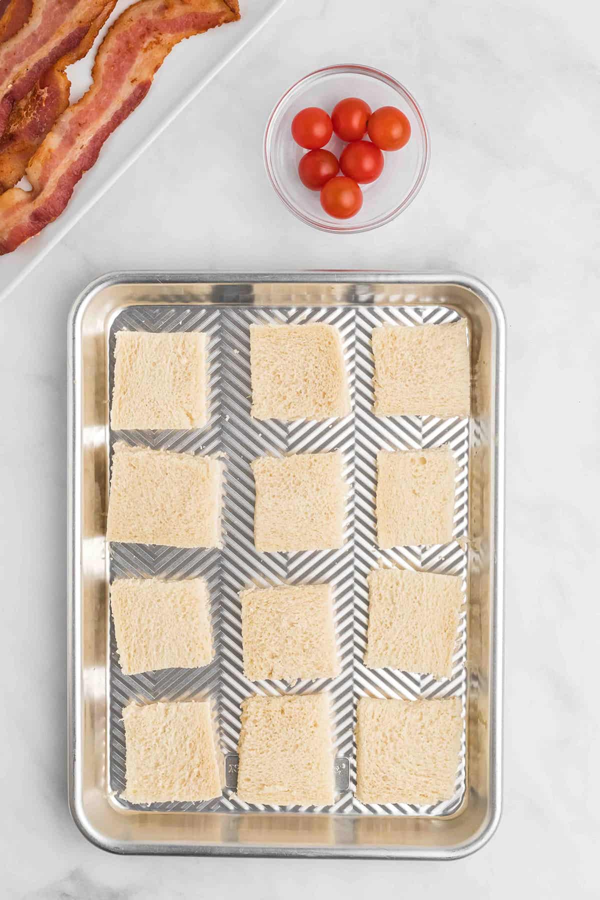 Bread rectangles placed on a baking sheet.