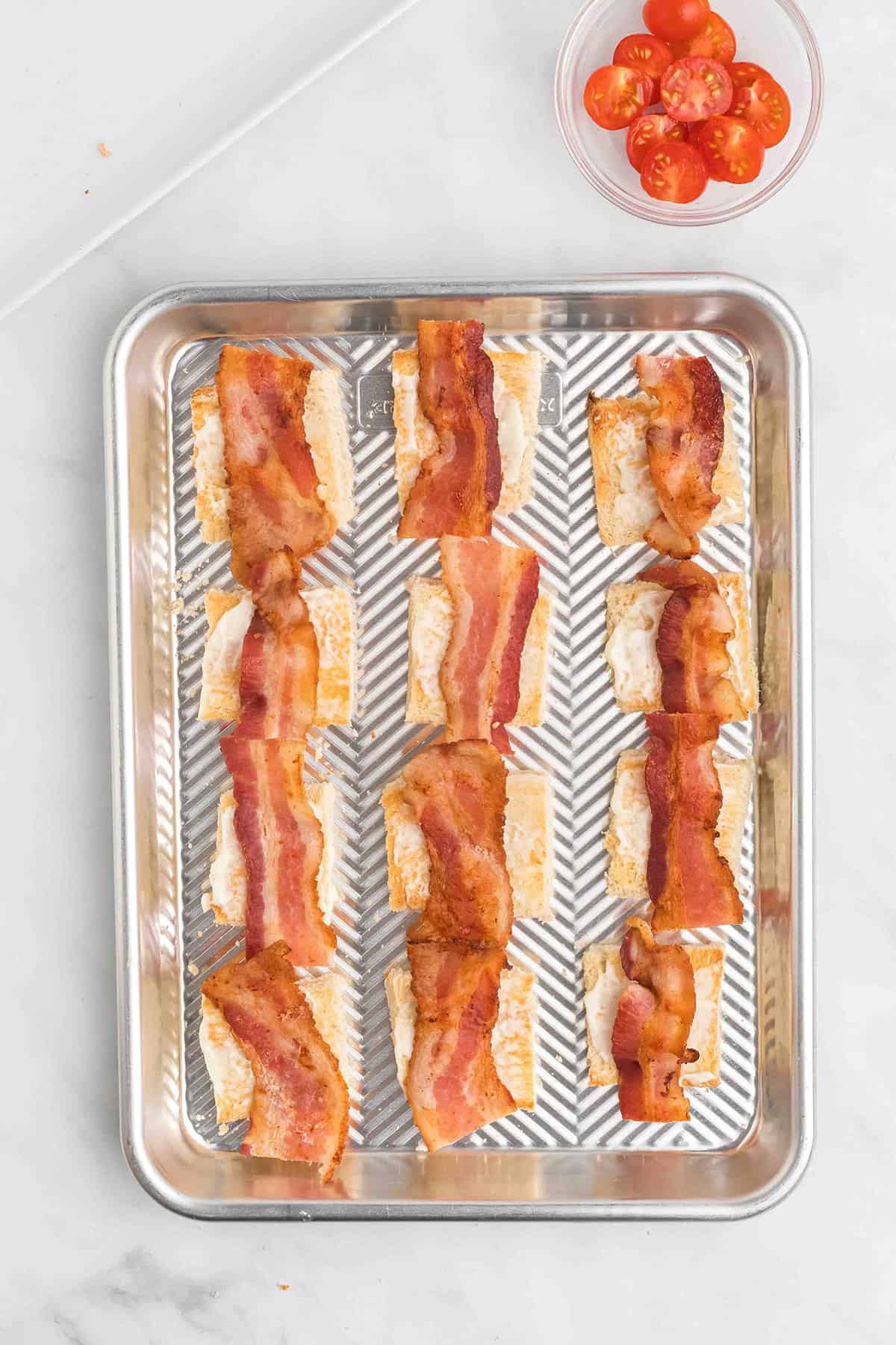 Bacon pieces added on top of mayonnaise.