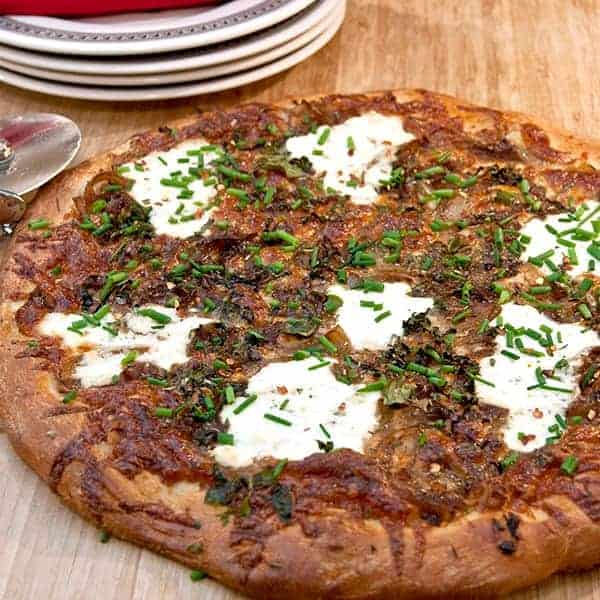 White Pizza with lots of fresh herbs, onions, and cheese, but no tomato sauce. A great change of pace for your weekly pizza night. https://www.lanascooking.com/white-pizza/