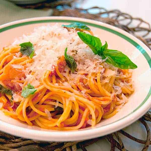 This Pasta with Tomato Basil Sauce is a perfect summer dinner. Pasta is tossed with tomatoes and loads of fresh basil. Topped with Parmigiano Reggiano. https://www.lanascooking.com/pasta-with-tomato-basil-sauce/