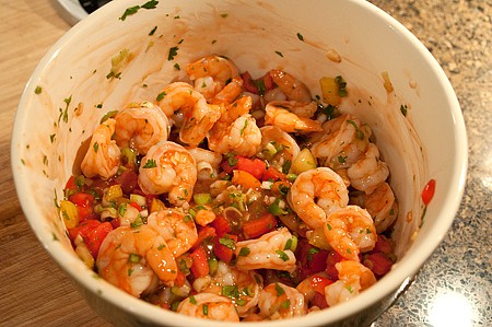 Combining boiled shrimp and vegetables.