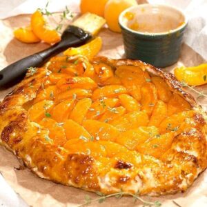 Apricot Thyme Galette is a freeform fruit tart made with an almond flour crust, fresh apricots and thyme. https://www.lanascooking.com/apricot-thyme-galette/