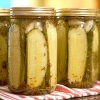 Our family's favorite dill pickles - Kosher dills with lots of fresh dill and garlic. Tested and approved safe canning recipe for shelf stable storage. https://www.lanascooking.com/favorite-kosher-dills/