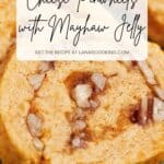 Close-up of a cheese pinwheel with visible chunks of nuts and mayhaw jelly, overlaid with text: “Cheese Pinwheels with Mayhaw Jelly.”.