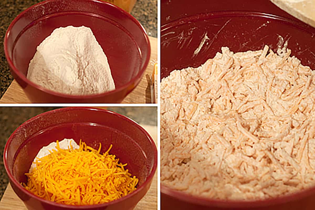 Three red bowls: one with flour, one with shredded cheddar and another ingredient, and one with a mixed dough containing shredded cheese.