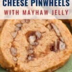 Close-up of cheese pinwheel cookies with visible nuts and mayhaw jelly swirls, placed on a green surface; text overlay describes the recipe and website.