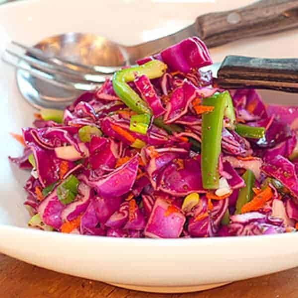 Red cabbage slaw with a sweet and tangy vinegar dressing. This slaw has no mayonnaise in the dressing so it's very low in calories. https://www.lanascooking.com/red-cabbage-slaw/