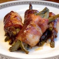 Barbecued Green Bean Bundles - whole green beans are wrapped in bacon and drizzled with barbecue sauce then baked until delicious! https://www.lanascooking.com/barbecued-green-beans/