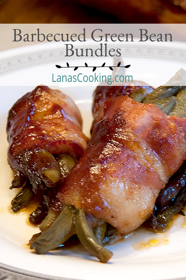 Barbecued Green Bean Bundles - whole green beans are wrapped in bacon and drizzled with barbecue sauce then baked until delicious!  https://www.lanascooking.com/barbecued-green-beans/