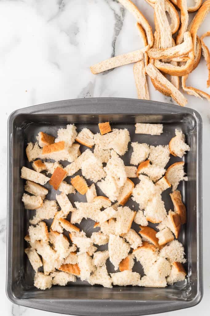 Bread pieces in a baking pan.