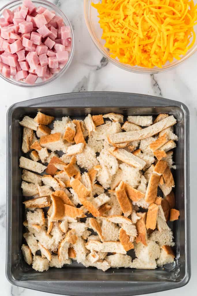 Excess bread and crusts in a baking pan.