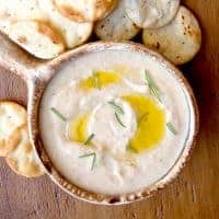 Add this Spicy White Bean Dip to your next tailgate menu or serve as an appetizer or snack for any occasion. https://www.lanascooking.com/spicy-white-bean-dip/