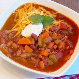 Vegetable Chili - this recipe for meatless vegetable chili is hearty, spicy and full of beans and veggies. Make it truly vegetarian with a vegetable stock. https://www.lanascooking.com/vegetable-chili/