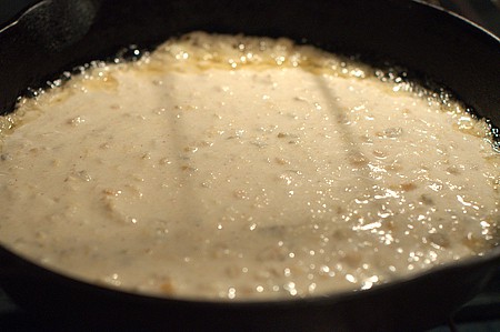 Cornbread batter bubbling around the edges.