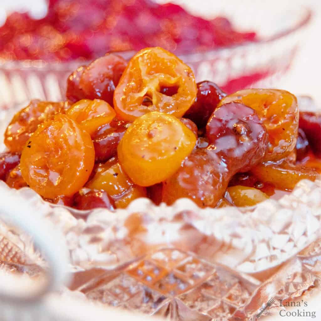 A crystal bowl filled with kumquat and dried cherry chutney.