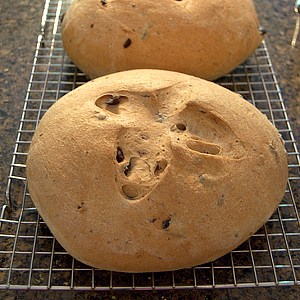 Olive rosemary bread cooling on a rack.