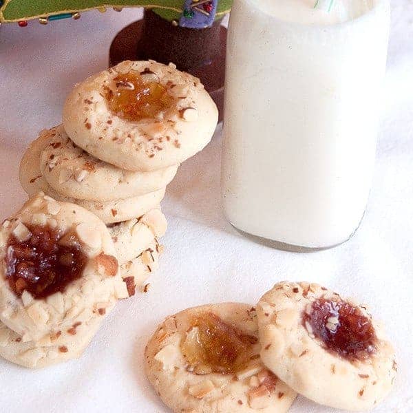 Thumbprint Jewels are tender, lemon-scented cookies, topped with nuts and their centers are filled with jam. From @Nevrenoughthyme https://www.lanascooking.com/thumbprint-jewels/