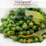 Finished peas and lettuce in a white serving bowl.
