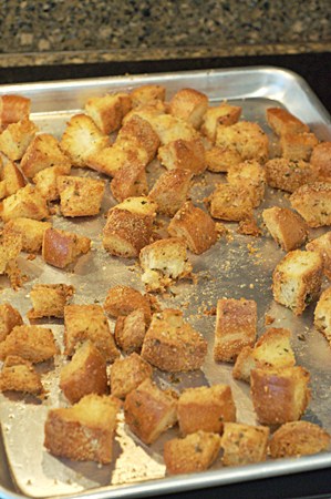 Golden brown croutons on a baking sheet.