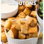 A bowl of homemade croutons, surrounded by greens and more croutons, with text promoting the recipe.