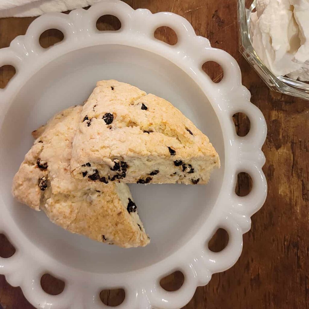 Two scones on a white plate.