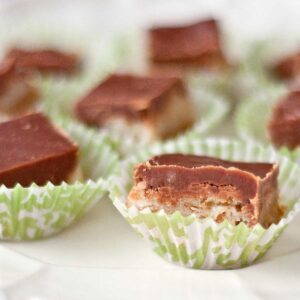 Homemade Mounds Bars Candy in paper cups on a serving platter.