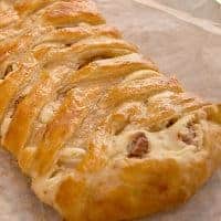Candied Pecan Cheese Braid - a beautifully golden cheese braid created with puff pastry, a cream cheese filling, and candied pecans. https://www.lanascooking.com/candied-pecan-cheese-braid/
