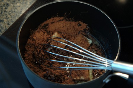 Butter and cocoa powder in a saucepan.