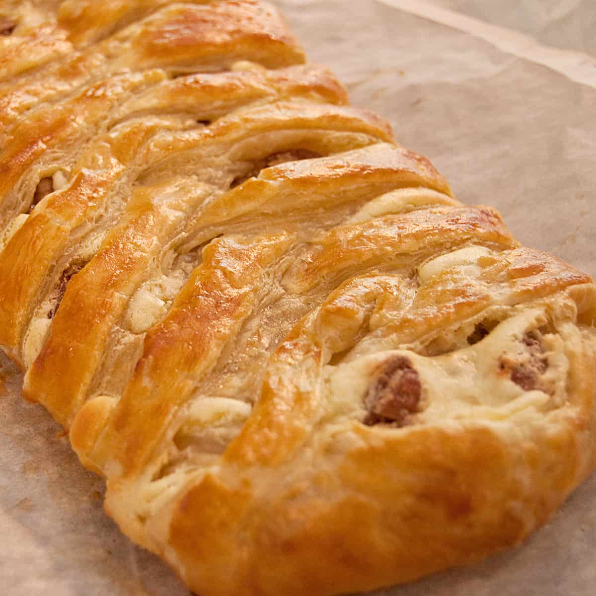 Finished braided danish cooling on parchment paper.