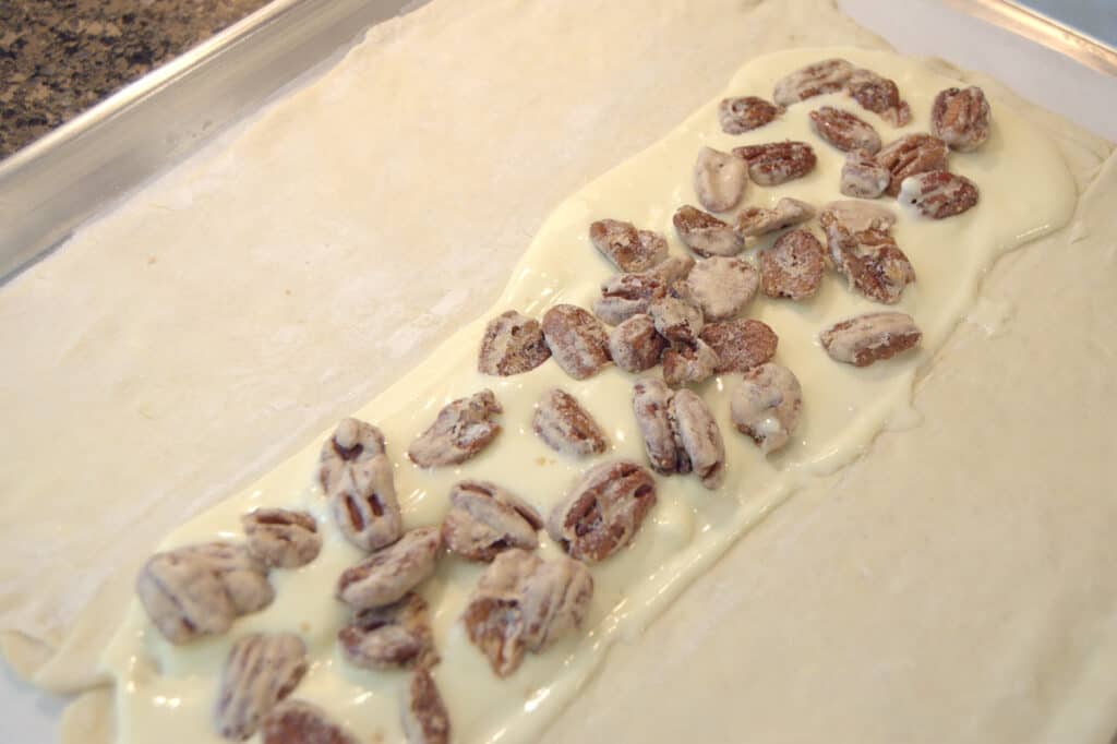 Candied pecans added on top of cream cheese mixture.