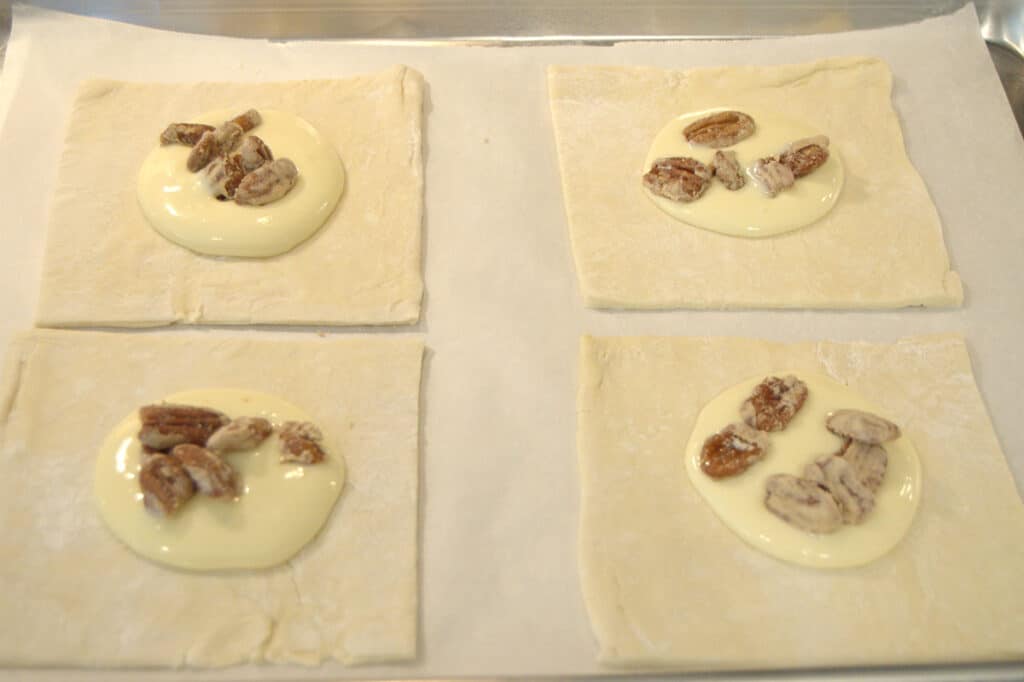 Individual danish pastries on a baking sheet.