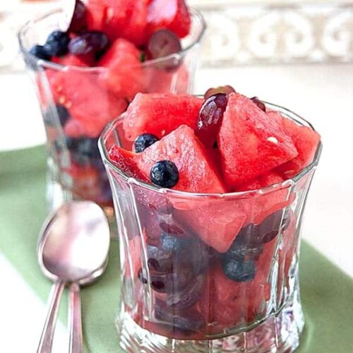 This Minty Watermelon Salad is a light, refreshing combination of watermelon, berries and grapes with a minty, ginger syrup. https://www.lanascooking.com/minty-watermelon-salad/