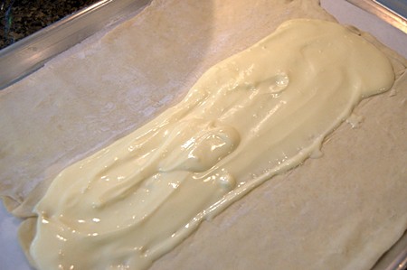 Cream cheese mixture spread into the center of a sheet of puff pastry.