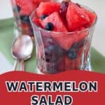 Two glasses of refreshing watermelon salad with blueberries, served with spoons and labeled as Watermelon Salad with Ginger-Mint Syrup.