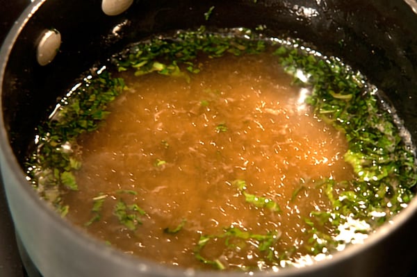 Minty Watermelon Salad Water, sugar, mint, and ginger cooking in a saucepan.
