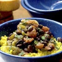 Black Beans with Saffron Rice - Black beans simmered with tomatoes and aromatic vegetables and served over fragrant saffron rice. https://www.lanascooking.com/black-beans-and-saffron-rice/