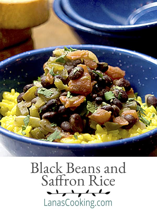 Black Beans with Saffron Rice - Black beans simmered with tomatoes and aromatic vegetables and served over fragrant saffron rice. https://www.lanascooking.com/black-beans-and-saffron-rice/