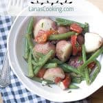 A delicious Warm Vegetable Salad with red skinned potatoes and green beans tossed in a tangy lemon-garlic dressing. Great year round side dish! https://www.lanascooking.com/warm-vegetable-salad/
