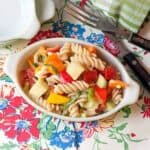 Summertime Pasta Salad - a cold pasta salad packed with fresh veggies and lightly dressed with a parmesan and garlic dressing. https://www.lanascooking.com/summertime-pasta-salad/