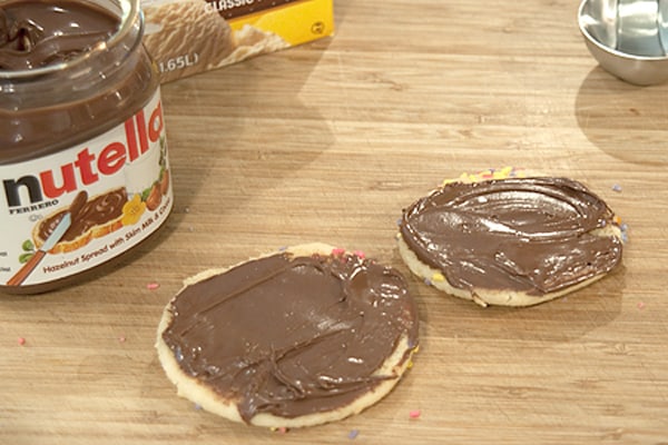 Two sugar cookies spread with Nutella.