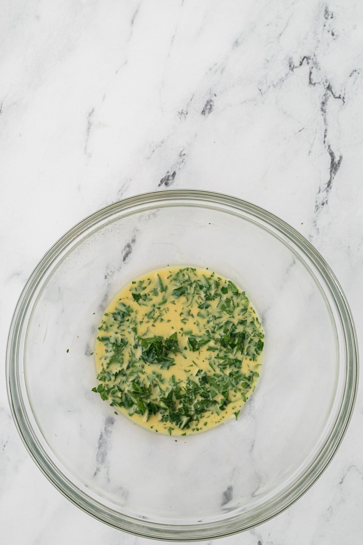 Parsley, mustard, lemon juice, salt, and pepper in a mixing bowl.