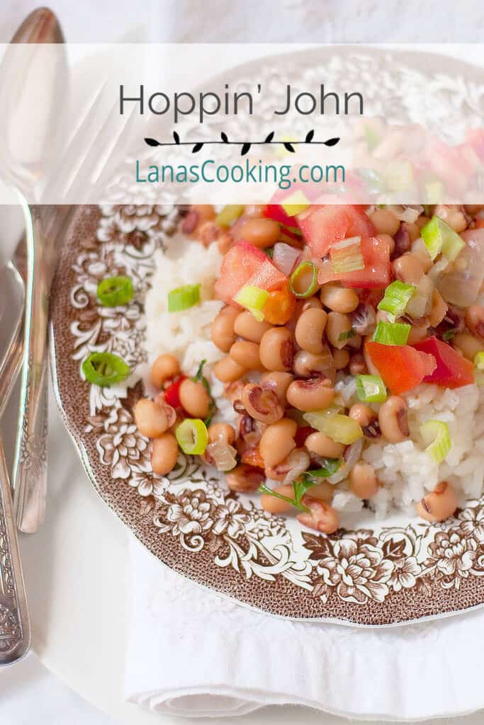 A serving of Hoppin' John on a vintage plate with antique flatware.